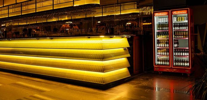 Close-up of the glowing gold-lit bar counter