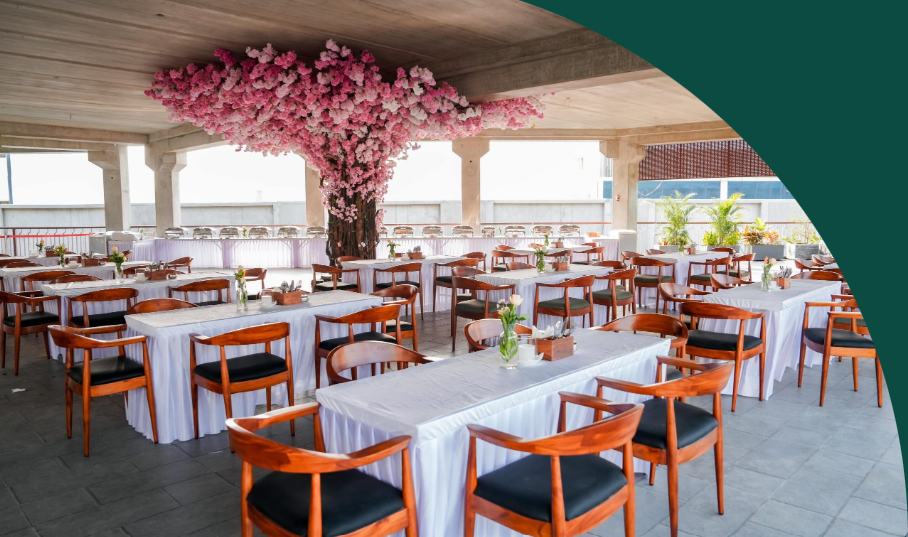 The Cherry Blossom Tree Space at Legacy Brewing Company, a private dining area beneath a blossoming tree canopy