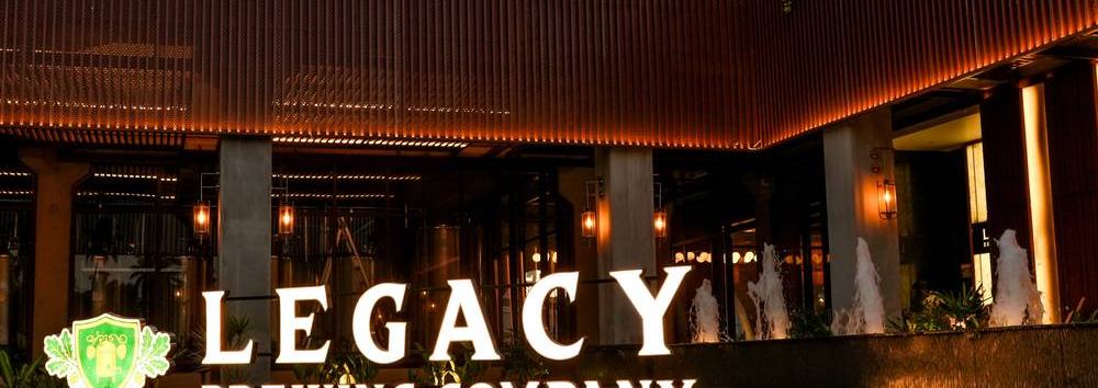 Close-up of the illuminated Legacy Brewing Company sign as you arrive